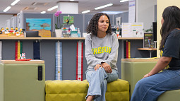 students sitting in campus office, talking
